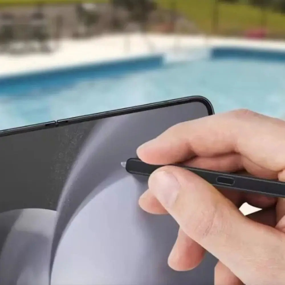 Stylus pen used on smartphone screen by poolside for precise touchscreen control and note taking