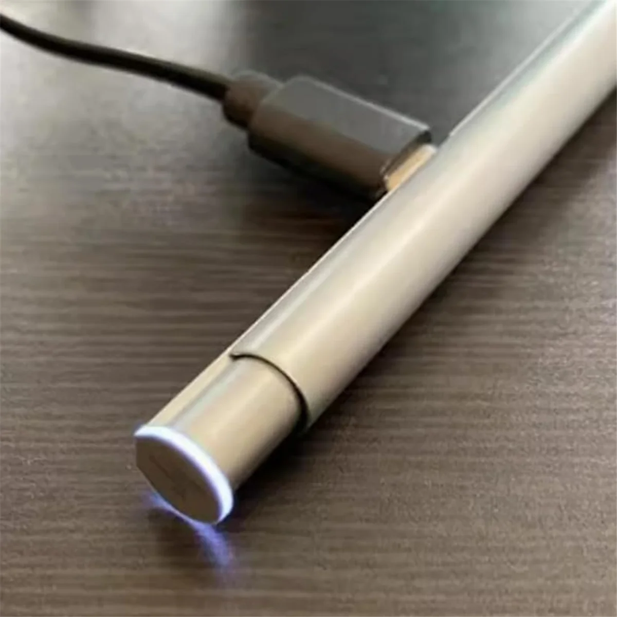Silver metal pen with illuminated tip and charging cable on desk HP Chromebook compatible stylus from Stylusshop