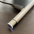 Silver metal pen with illuminated tip and charging cable on desk HP Chromebook compatible stylus from Stylusshop